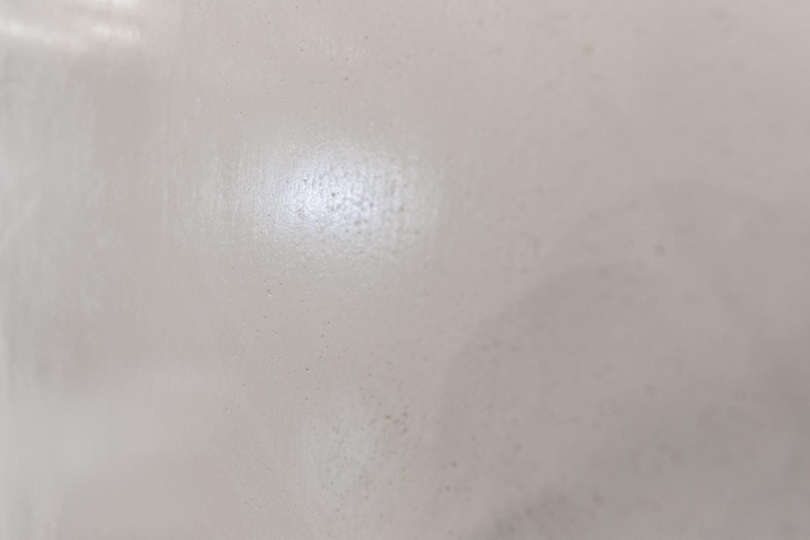 Close-up of white benchtop surface with subtle texture and light reflection
