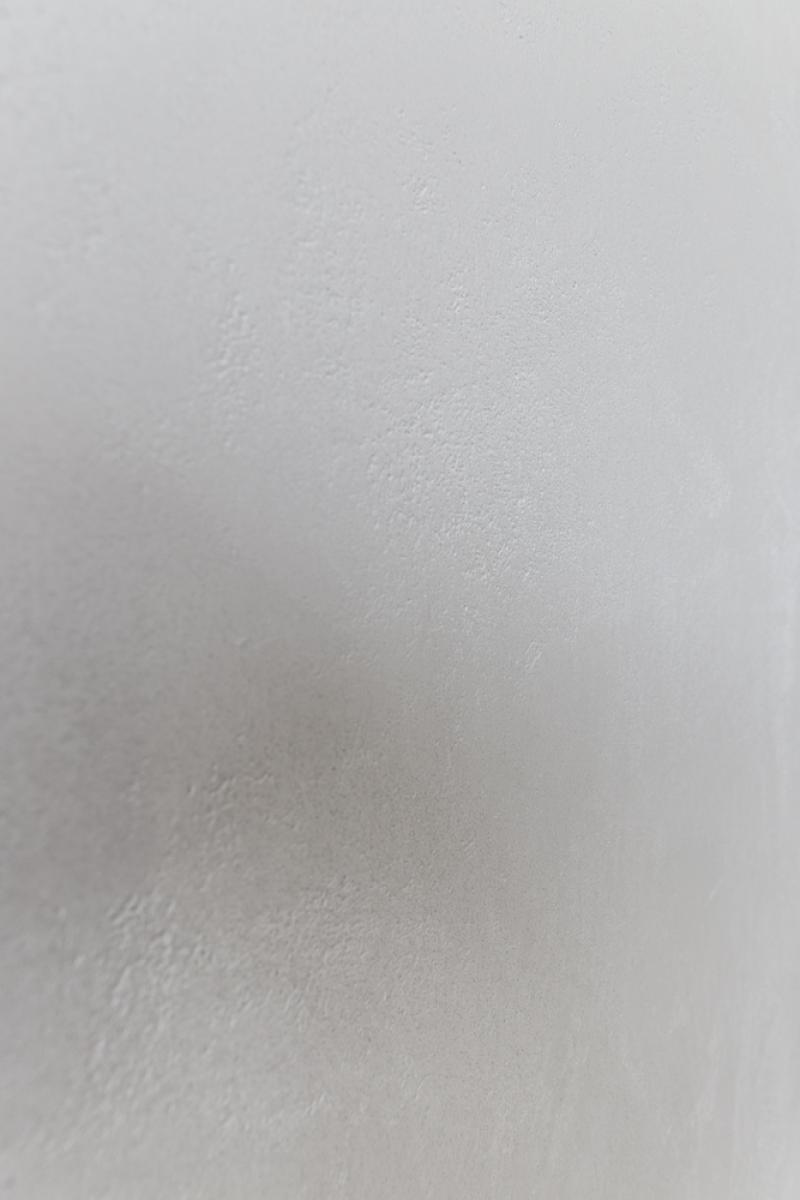 Close-up of textured white plasterwork wall finish showing detailed surface preparation