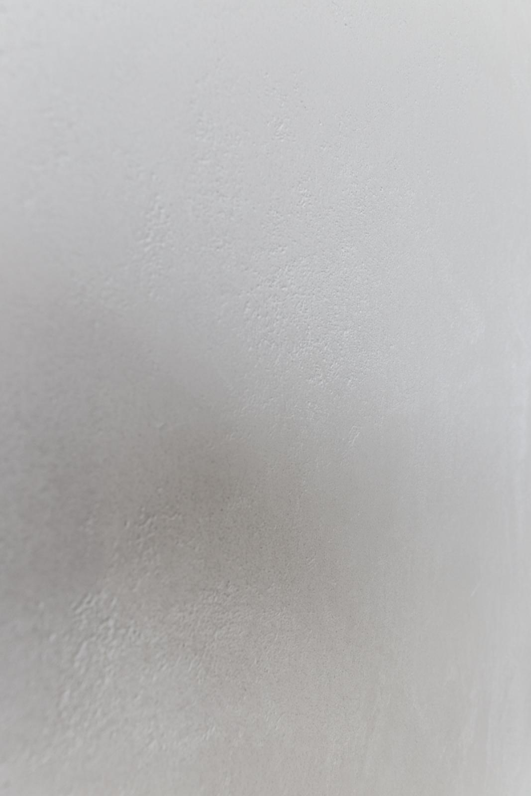 Close-up of textured white plasterwork wall finish showing detailed surface preparation