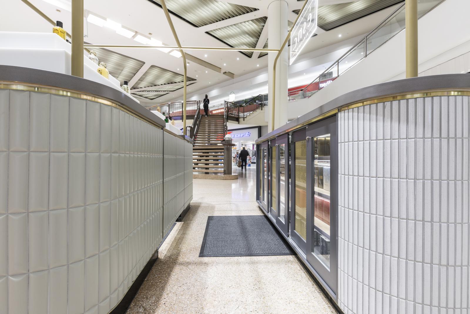 Modern commercial shopfront with corrugated metal cladding and glass display windows