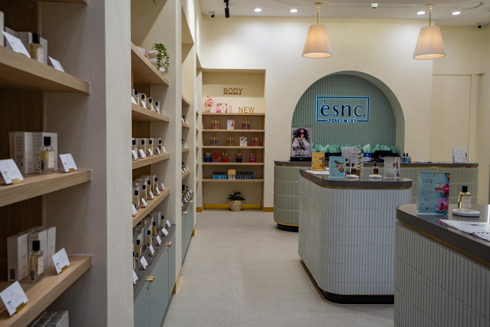Modern beauty clinic reception area with curved desk, product shelving, and contemporary design