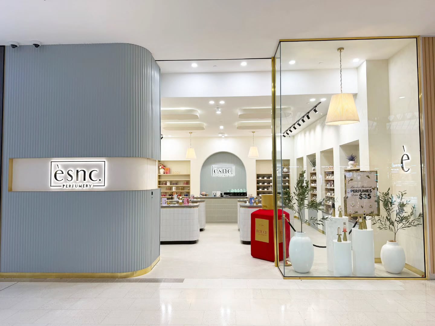 Modern beauty shop fitout with blue corrugated cladding, brass fixtures, and contemporary retail display